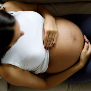 woman-holds-pregnant-belly-top-view-sq-400.jpg